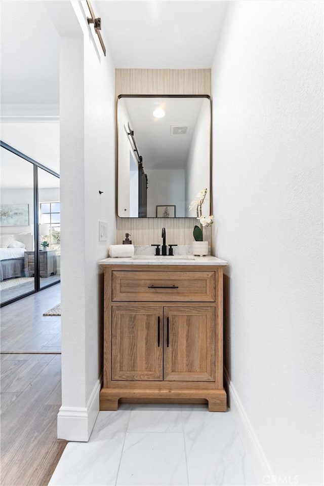 bathroom featuring tasteful backsplash, hardwood / wood-style floors, and vanity