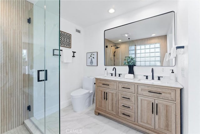 bathroom featuring an enclosed shower, vanity, and toilet