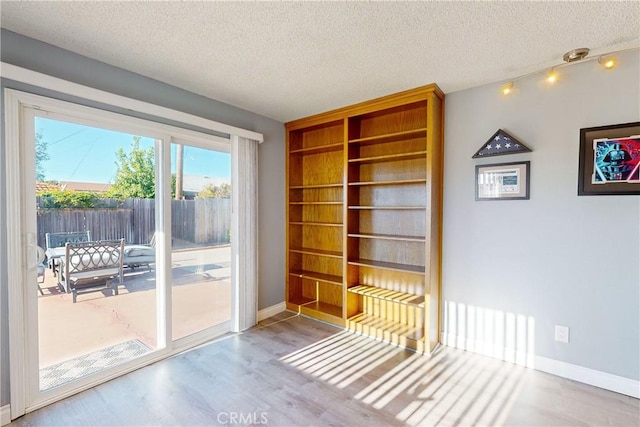 interior space with light hardwood / wood-style flooring and a textured ceiling