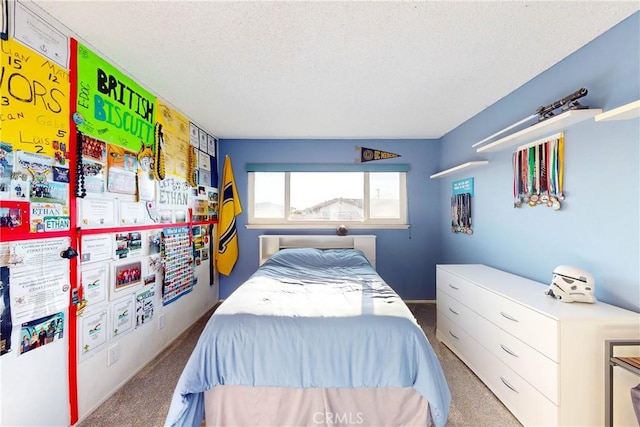 bedroom with carpet and a textured ceiling