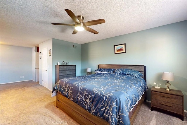 bedroom featuring ceiling fan, carpet, and a textured ceiling