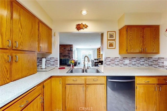 kitchen featuring backsplash, sink, and stainless steel dishwasher