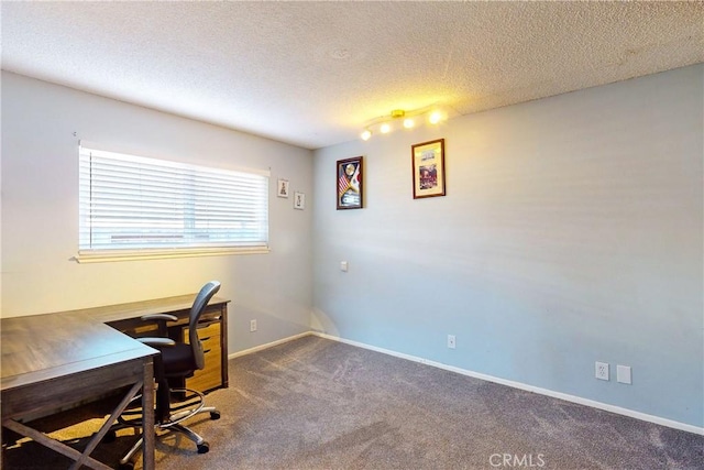 carpeted office featuring a textured ceiling