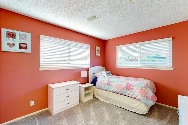 carpeted bedroom with a textured ceiling