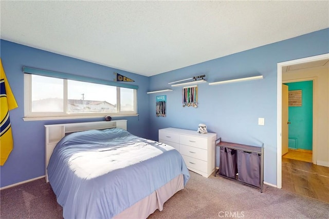 bedroom featuring carpet and a textured ceiling