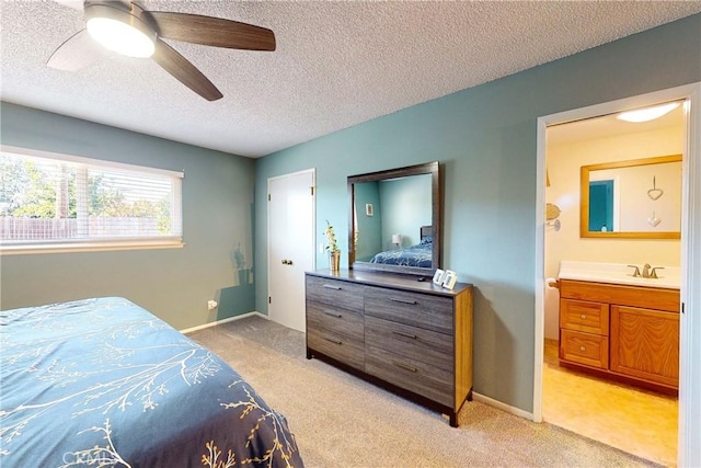 carpeted bedroom featuring a textured ceiling, ceiling fan, and sink