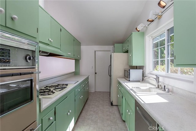 kitchen featuring green cabinetry, sink, and stainless steel appliances