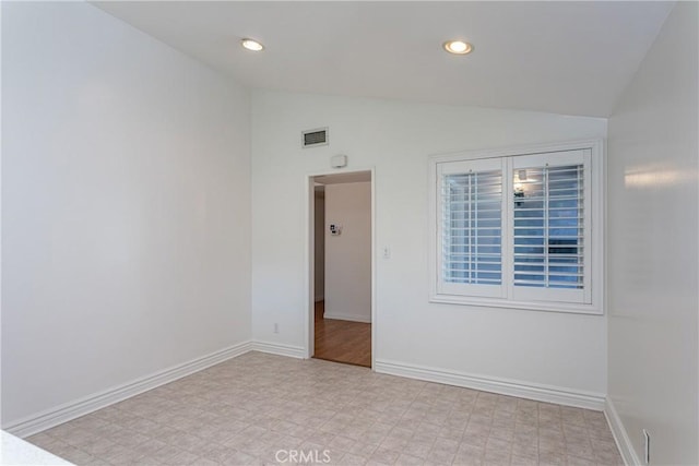 empty room with vaulted ceiling