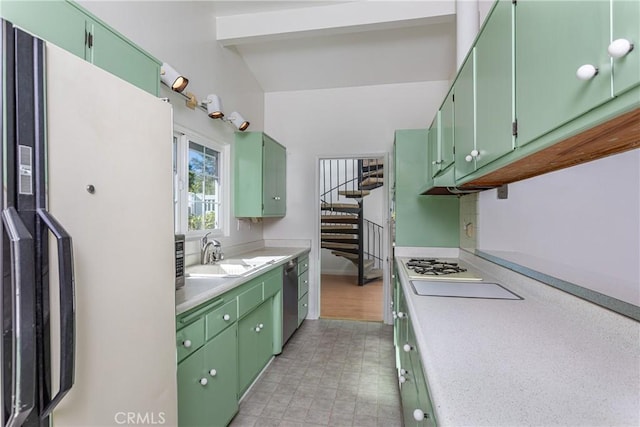 kitchen featuring green cabinets, dishwasher, sink, and white refrigerator