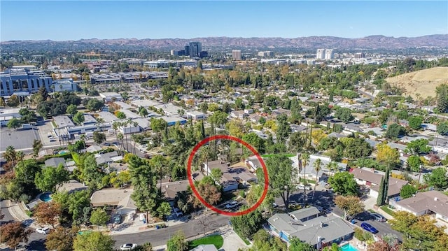 birds eye view of property with a mountain view