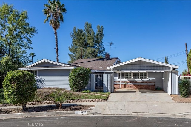 ranch-style home featuring a carport