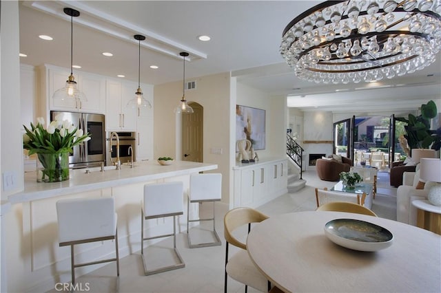 dining space with sink and a chandelier