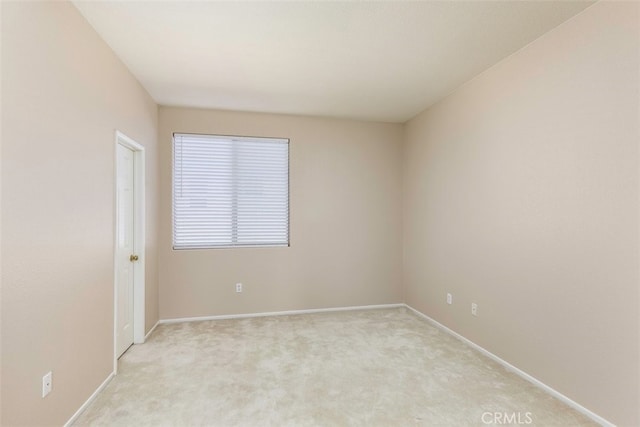 empty room with light carpet and baseboards