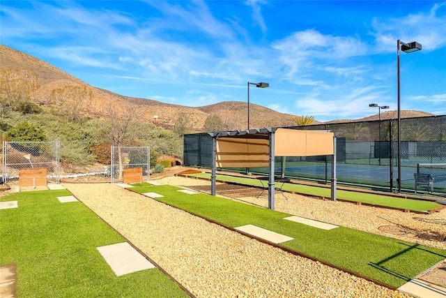 view of property's community with a mountain view and fence