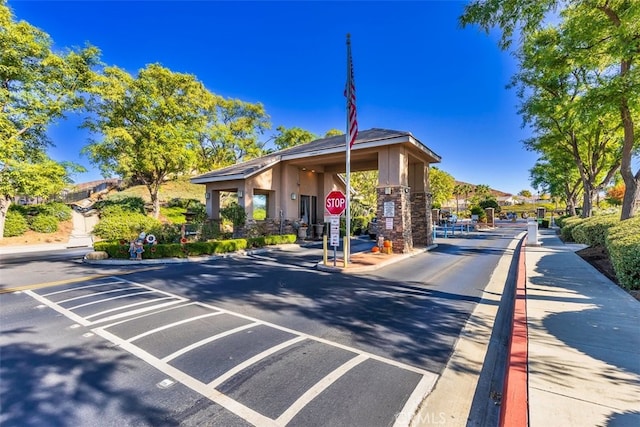 view of road featuring curbs, traffic signs, and sidewalks