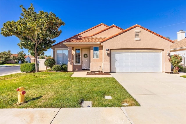 view of front of house with a garage, a front yard, driveway, and stucco siding