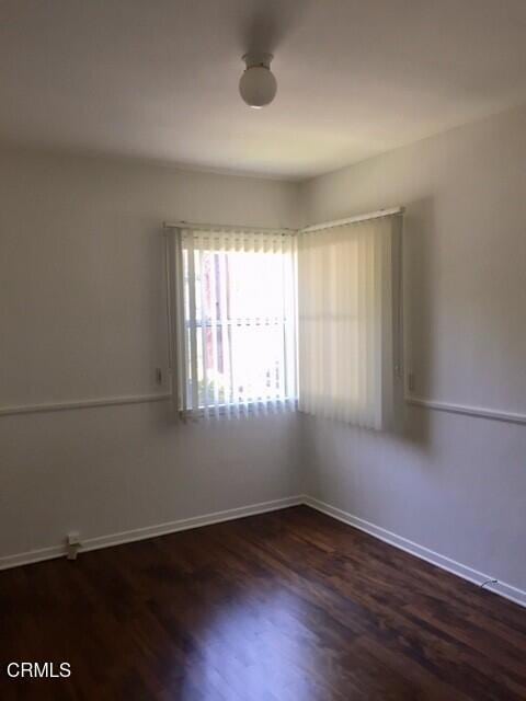 unfurnished room featuring dark hardwood / wood-style floors