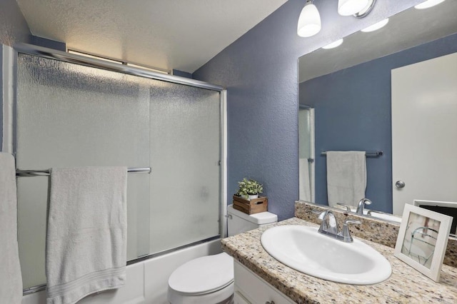 full bathroom featuring vanity, toilet, and bath / shower combo with glass door