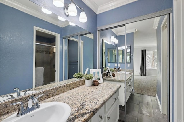 bathroom with walk in shower, vanity, and ornamental molding