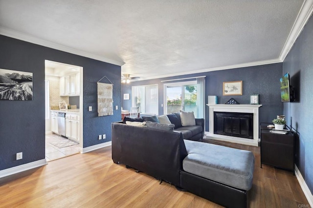 living room featuring a textured ceiling, ceiling fan, crown molding, and light hardwood / wood-style flooring