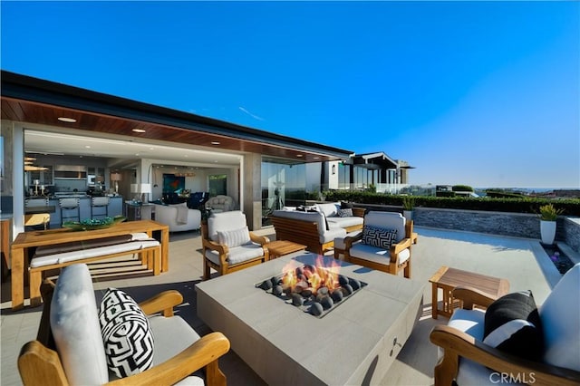 view of patio / terrace featuring an outdoor living space with a fire pit