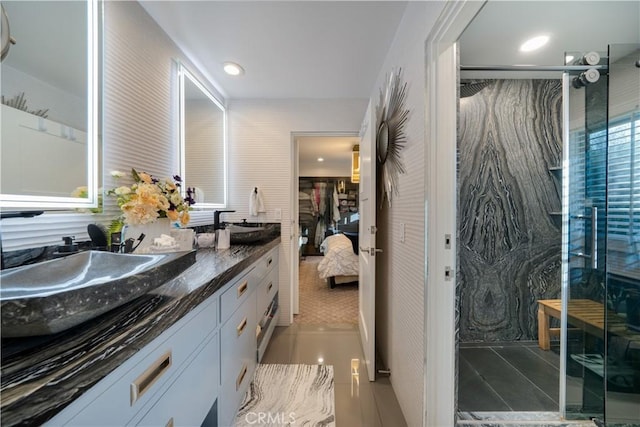 bathroom with tile patterned floors, vanity, and walk in shower