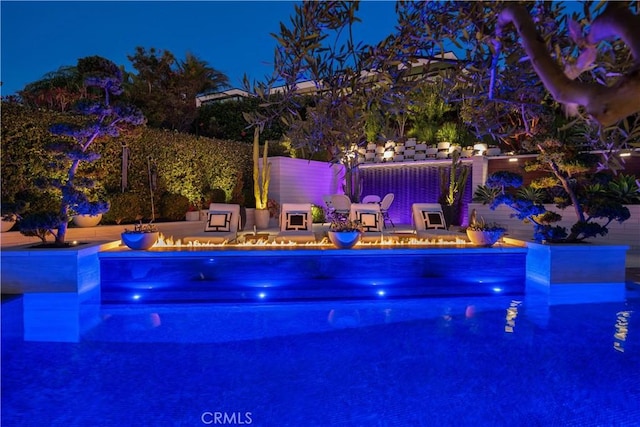 pool at night with a patio