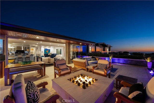 view of patio featuring an outdoor living space with a fire pit