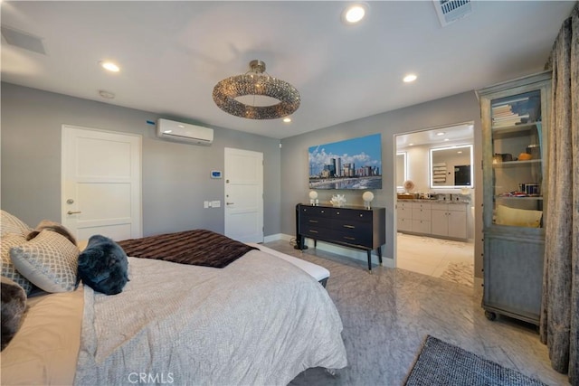 bedroom featuring a wall mounted air conditioner and ensuite bath