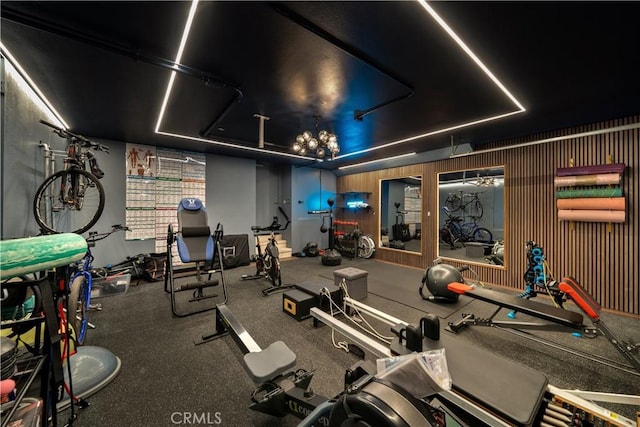 exercise room featuring a notable chandelier