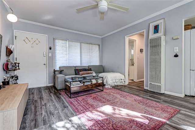 living room with ceiling fan, crown molding, and dark wood-type flooring