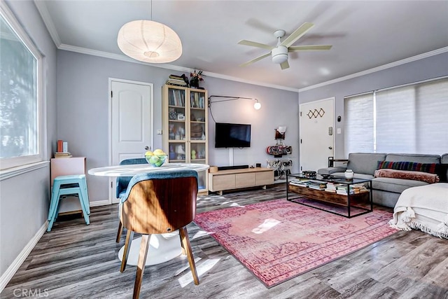 living room with ceiling fan, wood-type flooring, and ornamental molding