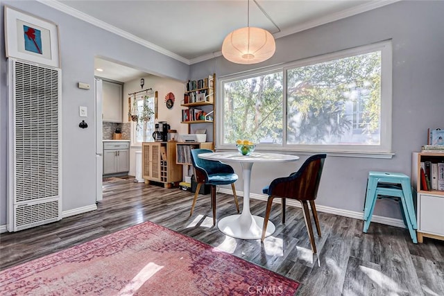 dining room featuring ornamental molding and dark wood-type flooring