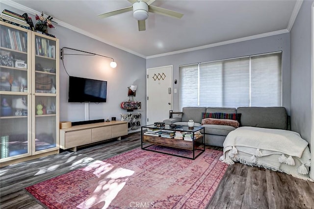 living room featuring wood-type flooring, ceiling fan, and crown molding