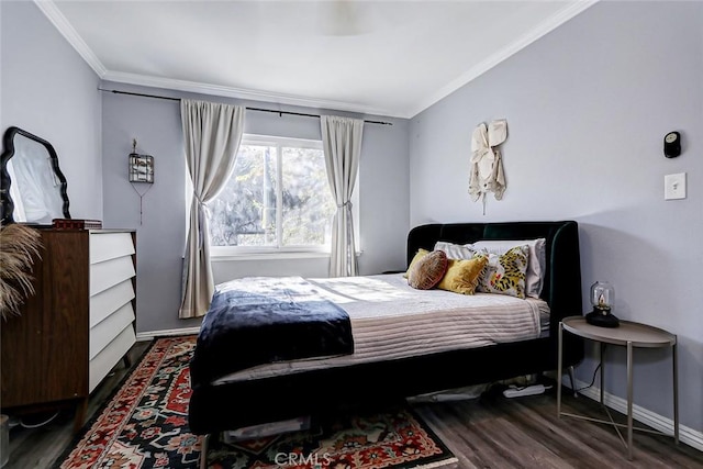 bedroom with crown molding and dark wood-type flooring