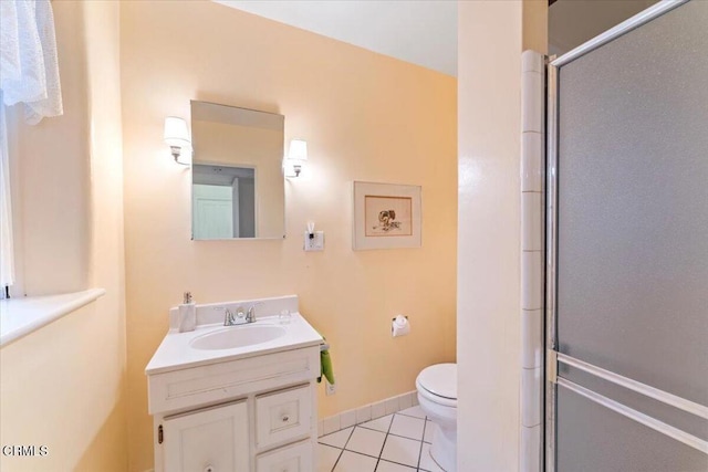 bathroom featuring toilet, vanity, tile patterned floors, and an enclosed shower