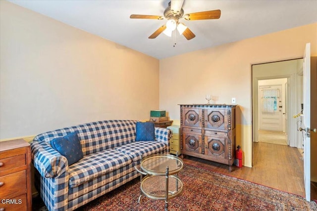 sitting room featuring hardwood / wood-style floors and ceiling fan