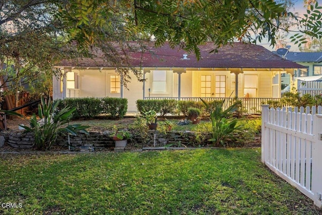 back of house with a lawn