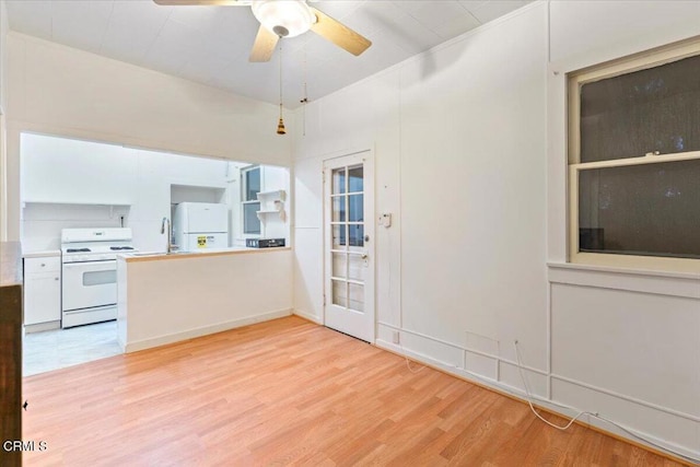 kitchen with white cabinets, light hardwood / wood-style floors, and white appliances