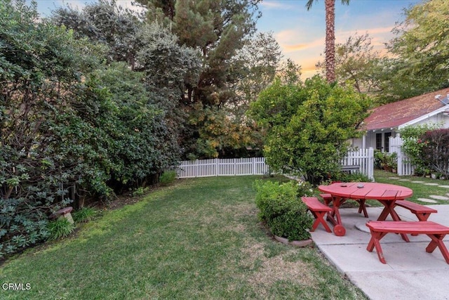 yard at dusk with a patio