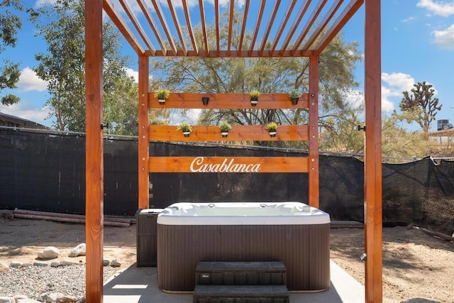 view of patio with cooling unit, a pergola, and a hot tub