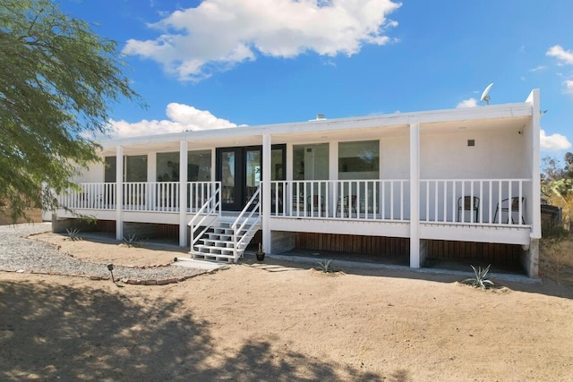 rear view of house featuring covered porch