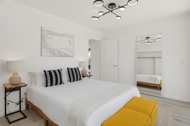 bedroom with light hardwood / wood-style floors, a spacious closet, and a closet