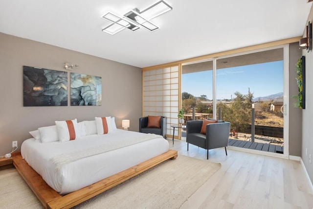 bedroom featuring access to outside and light hardwood / wood-style flooring