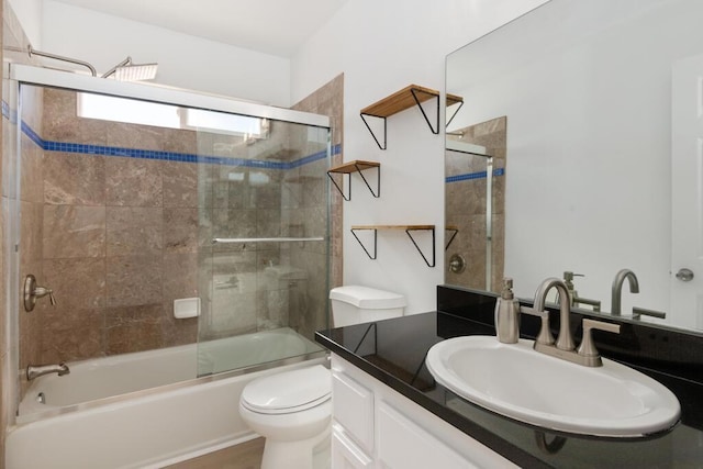 full bathroom with vanity, toilet, and enclosed tub / shower combo