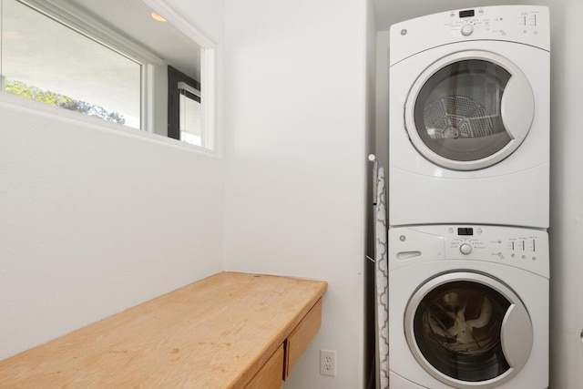 laundry area featuring stacked washer and clothes dryer