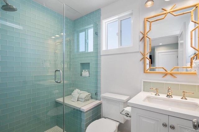 full bath with decorative backsplash, a shower stall, toilet, and vanity