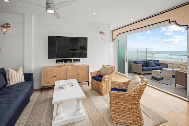 living area with recessed lighting, light wood-style floors, and a ceiling fan