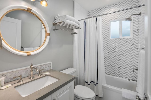 full bath with backsplash, vanity, toilet, and shower / tub combo