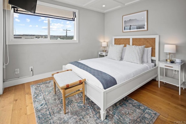 bedroom featuring baseboards and wood finished floors